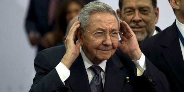 Cuba's President Raul Castro cups his ears to better hear a question shouted out at him during the official group photo of the VII Summit of the Americas, in Panama City, Panama, Saturday, April 11, 2015. In a speech to world leaders at the opening plenary session, Castro absolved President Barack Obama of fault for the U.S. blockade in a stunning reversal of more than 50 years of animosity between the United States and Cuba. (AP Photo/Moises Castillo)