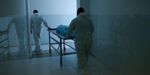 Members of the scientific team of Mexican dentist Alejandro Hernandez Cardenas carry a gurney with mummified human corpse to rehydrate it in a special chemical bath in an intent to rehydrate it, at the forensic scientific laboratory of the Attorney General, in Ciudad Juarez, Mexico on March 6, 2013. According to Cardenas, with the procces of his invention, it will be possible to recover certain body marks as fingerprints, tattoos, scars, moles or perforations, which are essential to identify victims of violence found in desert areas. AFP PHOTO/ JESUS ALCAZAR (Photo credit should read Jesus Alcazar/AFP/Getty Images)
