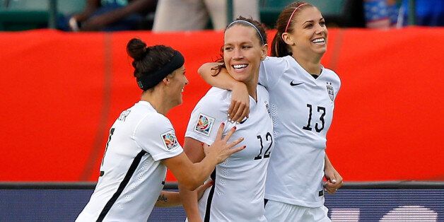 EDMONTON, AB - JUNE 22: Alex Morgan #13 of the United States celebrates with teammates Lauren Holiday #12 and Alex Krieger #11 after Morgan scores her first goal against goalkeeper Stefany Castano #1 of Colombia in the second half in the FIFA Women's World Cup 2015 Round of 16 match at Commonwealth Stadium on June 22, 2015 in Edmonton, Canada. (Photo by Kevin C. Cox/Getty Images)