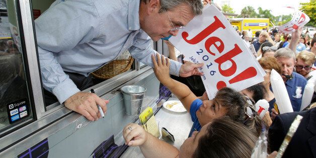 Former Florida Gov. Jeb Bush talks to supporters as he signs autographs from the window of a food truck after he formally announced that he would join the race for president with a speech at Miami Dade College, Monday, June 15, 2015, in Miami. (AP Photo/Wilfredo Lee)