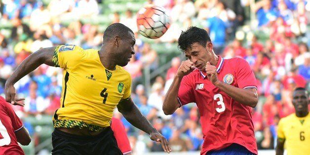 Giancarlo Conzalez of Costa Rica vies for the header with Wesley Morgan (L) of Jamaica during their 2015 Concacaf Gold Cup match in Carson, California on July 8, 2015, where the two teams played to a 2-2 draw. AFP PHOTO / FREDERIC J. BROWN (Photo credit should read FREDERIC J. BROWN/AFP/Getty Images)
