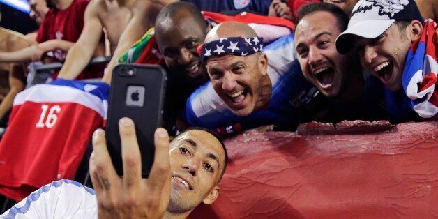 United States' Clint Dempsey takes a selfie with fans after the U.S. team defeated Haiti 1-0 in a CONCACAF Gold Cup soccer match in Foxborough, Mass., Friday, July 10, 2015. (AP Photo/Charles Krupa)