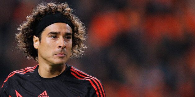 AMSTERDAM, NETHERLANDS - NOVEMBER 12: Goalkeeper, Guillermo Ochoa of Mexico looks ot the ball during the international friendly match between Netherlands and Mexico held at the Amsterdam ArenA on November 12, 2014 in Amsterdam, Netherlands. (Photo by Dean Mouhtaropoulos/Getty Images)