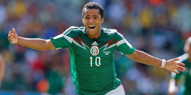 Mexico's Giovani dos Santos celebrates after scoring his side's first goal against Netherlands' goalkeeper Jasper Cillessen during the World Cup round of 16 soccer match between the Netherlands and Mexico at the Arena Castelao in Fortaleza, Brazil, Sunday, June 29, 2014. (AP Photo/Eduardo Verdugo)