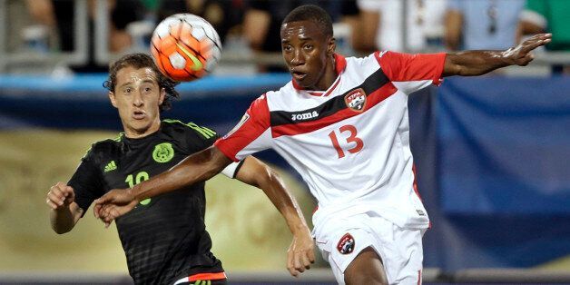 Trinidad & Tobagoâs Cordell Cato (13) and Mexicoâs Andres Guardado chase the ball during the first half of a CONCACAF Gold Cup soccer match in Charlotte, N.C., Wednesday, July 15, 2015. (AP Photo/Gerry Broome)