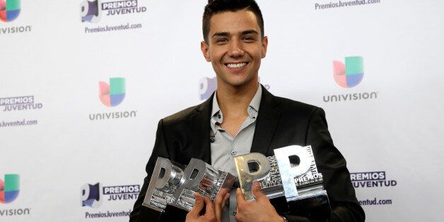 Luis Coronel poses with his four awards backstage at the Premios Juventud 2015, Thursday, July 16, 2015, in Coral Gables, Fla. (AP Photo/Lynne Sladky)