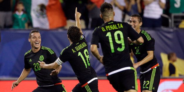 Mexico's Andres Guardado, (18) celebrates his goal with teammates during the first half of the CONCACAF Gold Cup championship soccer match against Jamaica, Sunday, July 26, 2015, in Philadelphia. (AP Photo/Michael Perez)
