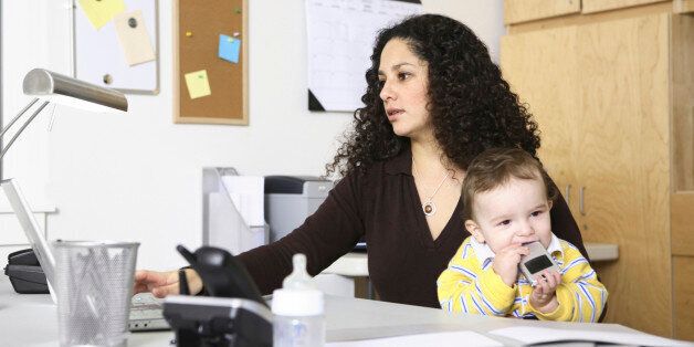 Woman in home office with child