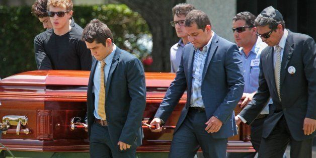 Pallbearers for 18-year-old graffiti artist Israel Hernandez Llach, who died after being shocked by a police officer's Taser, during the youth's funeral at Vista Memorial Gardens & Funeral Home in Plantation, Florida, on Wednesday, August 14, 2013. (Al Diaz/Miami Herald/MCT via Getty Images)