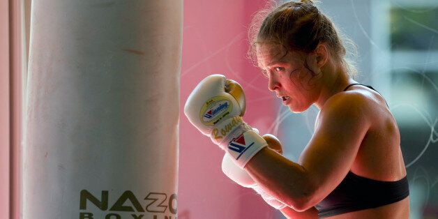 FILE - This July 15, 2015, file photo shows mixed martial arts fighter Ronda Rousey working out at Glendale Fighting Club in Glendale, Calif. Paramount Pictures said Monday, Aug. 3, that it has acquired the rights to Rouseyâs autobiography âMy Fight/Your Fight,â with plans for Rousey to play herself in the adaptation. (AP Photo/Jae C. Hong, File)