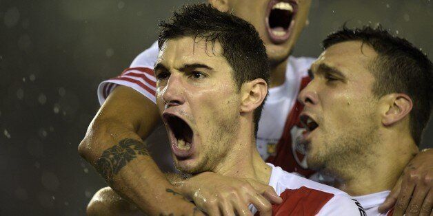 Argentina's River Plate forward Lucas Alario (L, bottom) celebrates with teammates after scoring against Mexican Tigres during their Libertadores Cup second leg final match at Americo Vespucio stadium, in Buenos Aires, on August 5, 2015. AFP PHOTO/JUAN MABROMATA (Photo credit should read JUAN MABROMATA/AFP/Getty Images)