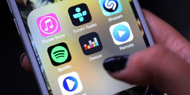 The Deezer music mobile app, centre, sits amongst other music apps on an Apple Inc. iPhone 6 in this arranged photograph in London, U.K., on Tuesday, Aug. 18, 2015. Deezer is seeking funds from investors in a transaction that could value the French music-streaming service at about 1 billion euros ($1.1 billion), according to people familiar with the matter. Photographer: Chris Ratcliffe/Bloomberg via Getty Images