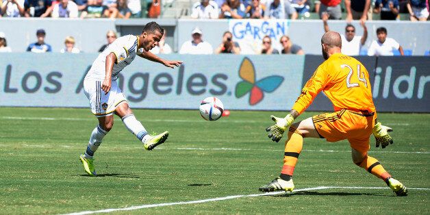 CARSON CA - AUGUST 9: Making his MLS debut Giovani Dos Santos #10 of the Los Angeles Galaxy scores a goal against goalkeeper Stefan Frei #24 of the Seattle Sounders during the second half at StubHub Center August 9, 2015, in Carson, California. (Photo by Kevork Djansezian/Getty Images)
