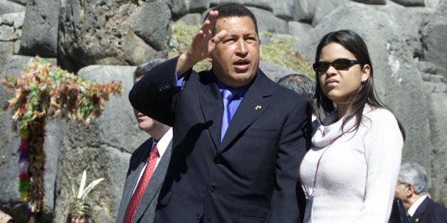 Venezuelan President Hugo Chavez, accompanied by his daughter Maria Gabriela waves during the closing ceremony of the Group of Rio Summit in the Sacsayhuaman ruins near Cusco, Peru, 24 May, 2003. Leaders attending the summit agreed to tackle Colombia's civil war, in a step toward a 'Latin American agenda' that would distance their nations from US policy.AFP PHOTO/ALEJANDRA BRUN (Photo credit should read ALEJANDRA BRUN/AFP/Getty Images)
