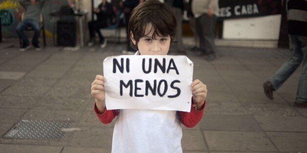 A child takes part in the demonstration 'Ni una menos' (Not One Less) against feminicide (a sort of genre violence consisting in the murder of women) in Buenos Aires, on June 3, 2015. AFP PHOTO / Eitan ABRAMOVICH (Photo credit should read EITAN ABRAMOVICH/AFP/Getty Images)