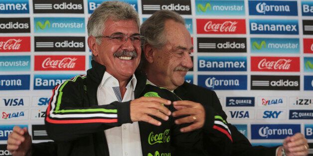 MEXICO CITY, MEXICO - AUGUST 24: Decio de Maria president of FEMEXFUT helps Ricardo Ferretti head coach of Mexico to wear a Mexico's national team jacket during a press conference to unveil Ferretti as new coach of Mexico at Alto Rendimiento Centre on August 24, 2015 in Mexico City, Mexico. (Photo by Hector Vivas/LatinContent/Getty Images)