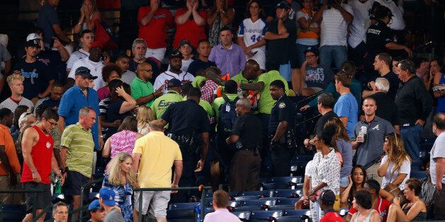 ATLANTA, GA - AUGUST 29: Emergency medical staff help a fan that fell from the upper deck of Turner Field during the game between the Atlanta Braves and the New York Yankees on August 29, 2015 in Atlanta, Georgia. (Photo by Mike Zarrilli/Getty Images)