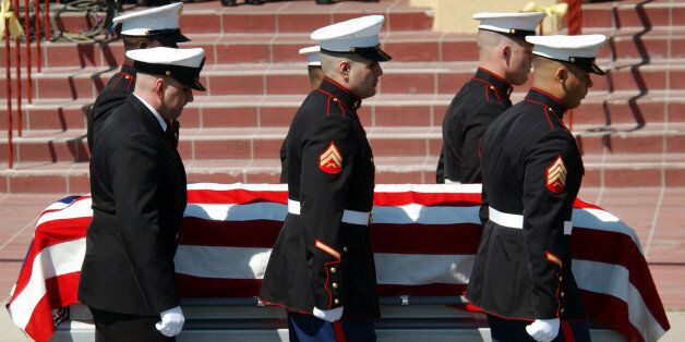 LOMITA, CA - APRIL 7: U.S. Marines carry the body of U.S. Marine Lance Cpl. Jose Gutierrez, one of the first Americans killed in the U.S.-led Operation Iraqi Freedom March 21, into St. Margaret Mary Alacoque Catholic Church prior to his memorial mass April 7, 2003 in the Los Angeles area city of Lomita, California. Gutierrez came to the U.S. as an illegal immigrant from his native Guatemala and was posthumously made a citizen of the U.S. (Photo by David McNew/Getty Images)