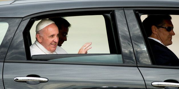 Pope Francis waves from a Fiat 500L as his motorcade departs Andrews Air Force Base, Md., Tuesday, Sept. 22, 2015, after being greeted by President Barack Obama and first lady Michelle Obama. (AP Photo/Andrew Harnik)