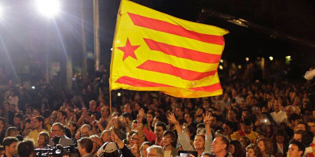 A "estelada" or pro independence flag is waved as Catalonian independence supporters react in Barcelona, Spain, Sunday Sept. 27, 2015. Voters in Catalonia participated in an election Sunday that could propel the northeastern region toward independence from the rest of Spain or quell secessionism for years. Secessionists have long pushed for an independence referendum, but Spain's central government has not allowed one, arguing it would be unconstitutional because only it can call such a vote. (AP Photo/Emilio Morenatti)