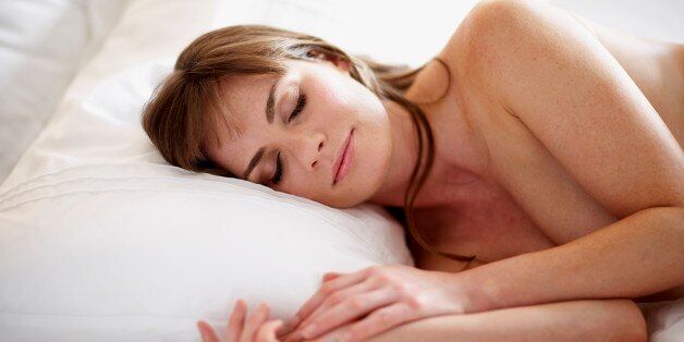 Woman sleeping in bed with head on pillow