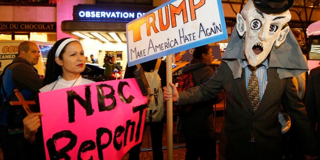 Protesters opposed to the appearance of Republican presidential candidate Donald Trump as a guest host on this weekend's "Saturday Night Live," demonstrate in front of NBC Studios where the television show is taped and broadcast, Wednesday, Nov. 4, 2015, in New York. (AP Photo/Kathy Willens)