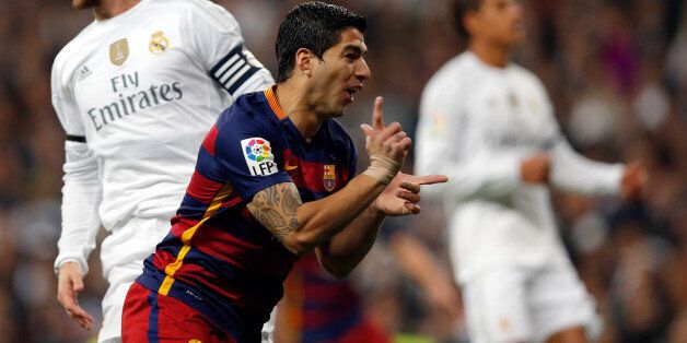 Barcelona's Luis Suarez celebrates after scoring the opening goal during the first clasico of the season between Real Madrid and Barcelona at the Santiago Bernabeu stadium in Madrid, Spain, Saturday, Nov. 21, 2015. (AP Photo/Daniel Ochoa de Olza)