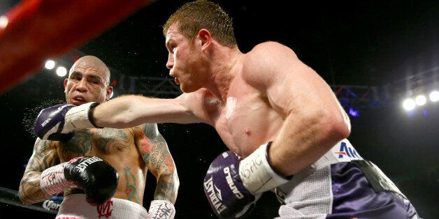 LAS VEGAS, NV - NOVEMBER 21: (R-L) Canelo Alvarez throws a right at Miguel Cotto during their middleweight fight at the Mandalay Bay Events Center on November 21, 2015 in Las Vegas, Nevada. (Photo by Al Bello/Getty Images)