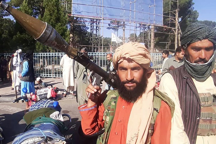 A Taliban fighter holds a rocket-propelled grenade (RPG) along the roadside in Herat, Afghanistan's third biggest city, after government forces pulled out the day before following weeks of being under siege. (Photo by - / AFP) (Photo by -/AFP via Getty Images)