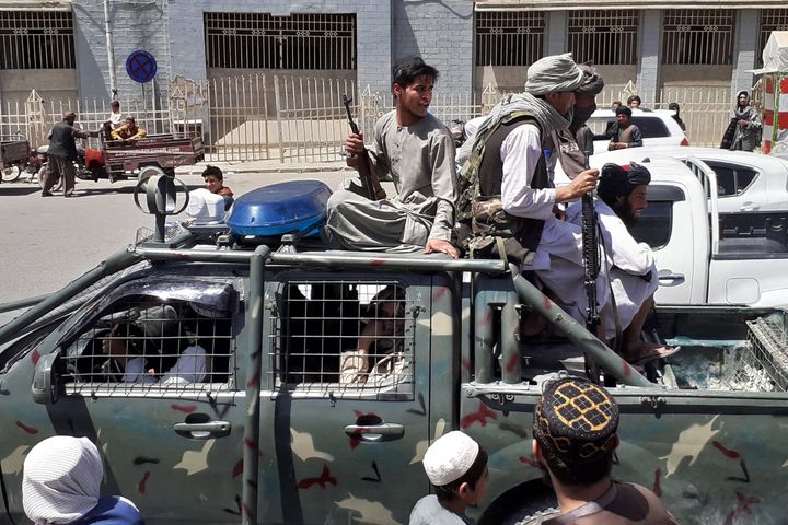 Taliban fighters are pictured in a vehicle of Afghan National Directorate of Security (NDS) on a street in Kandahar. 