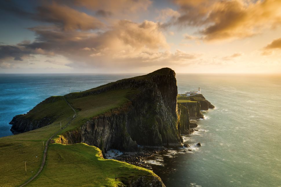 Neist Point and the lighthouse on Isle of Skye at sunset in Scotland,