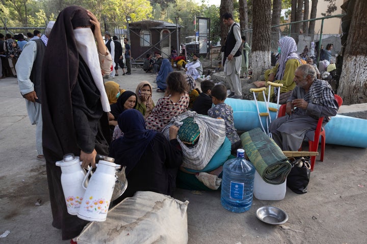 Displaced Afghans from the northern provinces are evacuated from a makeshift camp to various mosques and schools.