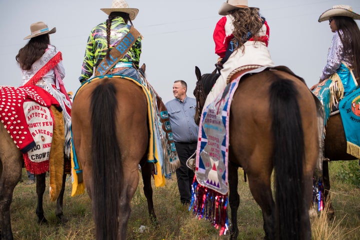 Sen. Jon Tester (D-Mont.) talks with constituents before a parade at Crow Fair in Crow Agency, Montana, on Aug. 19, 2018. Tes