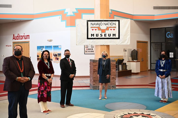 First Lady Jill Biden (C) is greeted by Navajo Nation President Jonathan Nez (out of frame) and his wife Phefelia Nez (R) upo