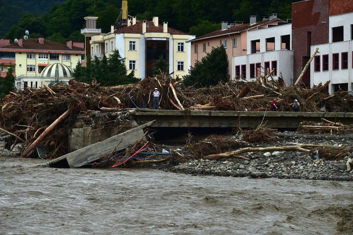 A man watches the destruction after floods and mudslides killed about three dozens of people, in Bozkurt town of Kastamonu province, Turkey, Friday, Aug. 13, 2021. 