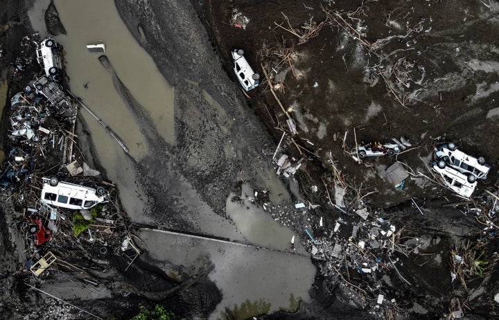 An aerial photo shows overturned cars among destruction in a mud-covered street in Bozkurt town of Kastamonu province, Turkey, Saturday, Aug. 14, 2021.