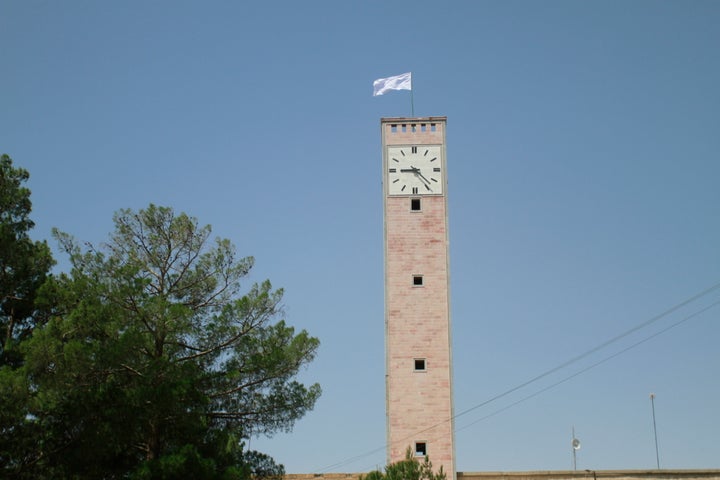 A Taliban flag flies from the clocktower of the Herat provincial official office, in Herat, Afghanistan, west of Kabul, on Saturday, Aug. 14, 2021.