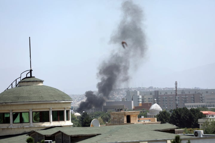 Smoke rises next to the U.S. Embassy in Kabul, Afghanistan, Sunday, Aug. 15, 2021. (AP Photo/Rahmat Gul)