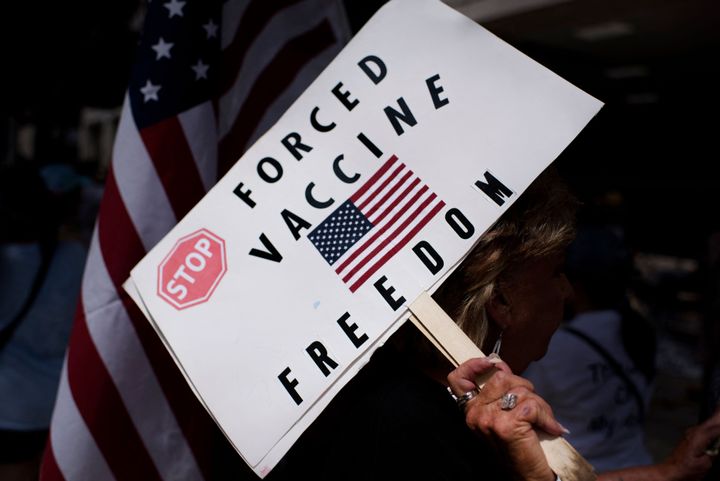 Anti-vaccine rally protesters hold signs outside of Houston Methodist Hospital in Houston, Texas, on June 26, 2021