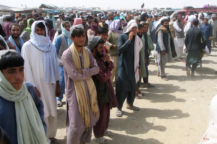 People wait to cross at the Friendship Gate crossing point at the Pakistan-Afghanistan border town of Chaman, Pakistan on Sun