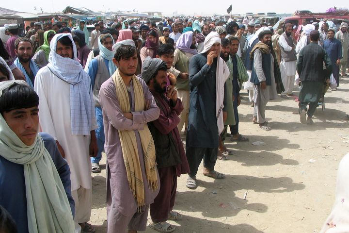 People wait to cross at the Friendship Gate crossing point at the Pakistan-Afghanistan border town of Chaman, Pakistan on Sunday.
