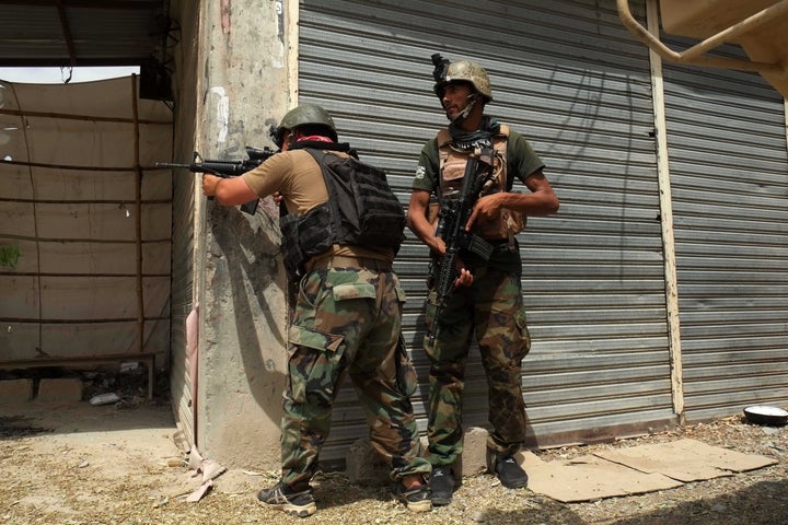 An Afghan security force member exchanges fire with Taliban militants after U.S. forces conducted an airstrike in Kandahar ci