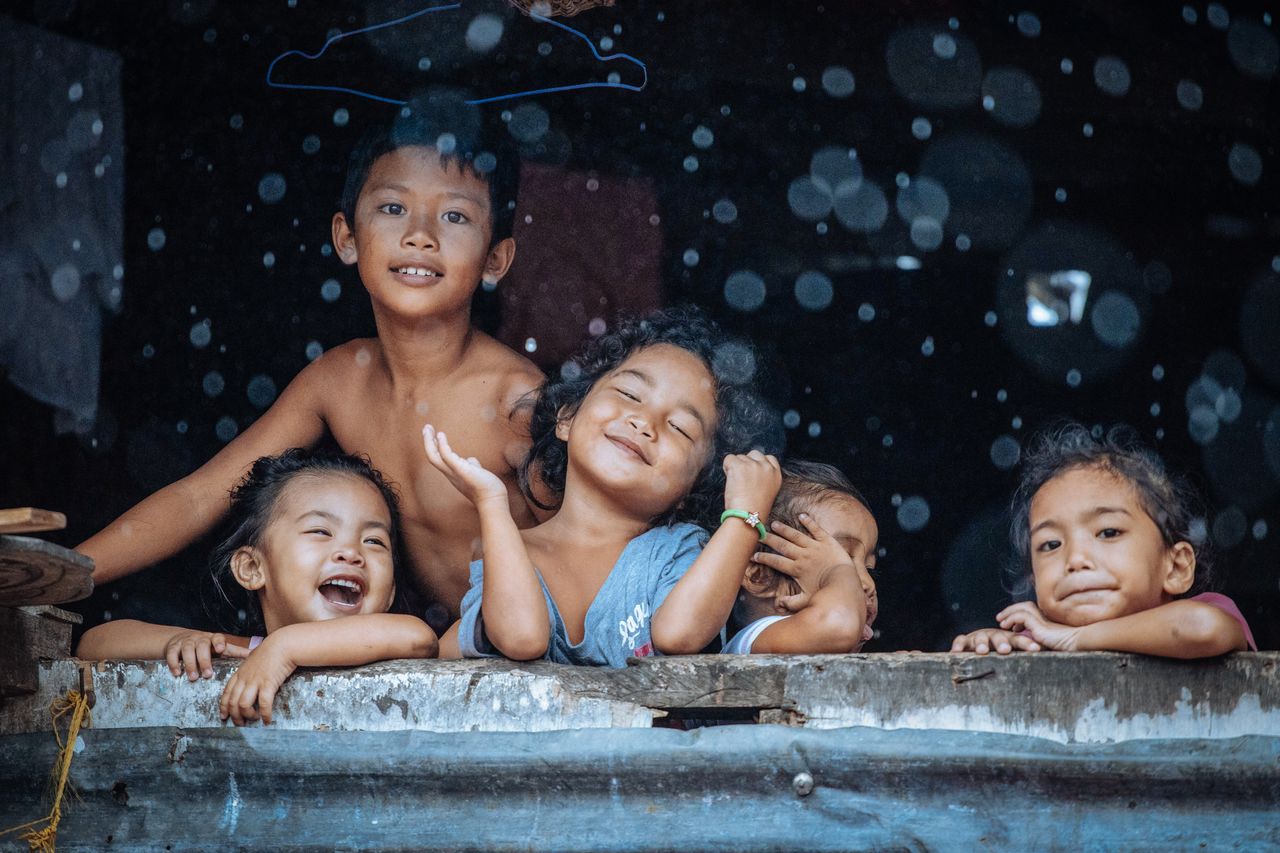 People category: A group of young children in the Philippines smiling and laughing