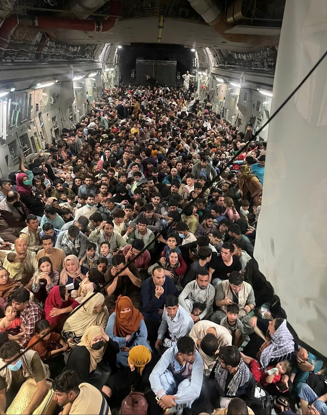 Evacuees crowd the interior of a U.S. Air Force C-17 Globemaster III transport aircraft