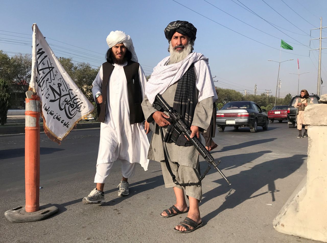 Taliban fighters stand outside the Interior Ministry in Kabul, Afghanistan, August 16, 2021
