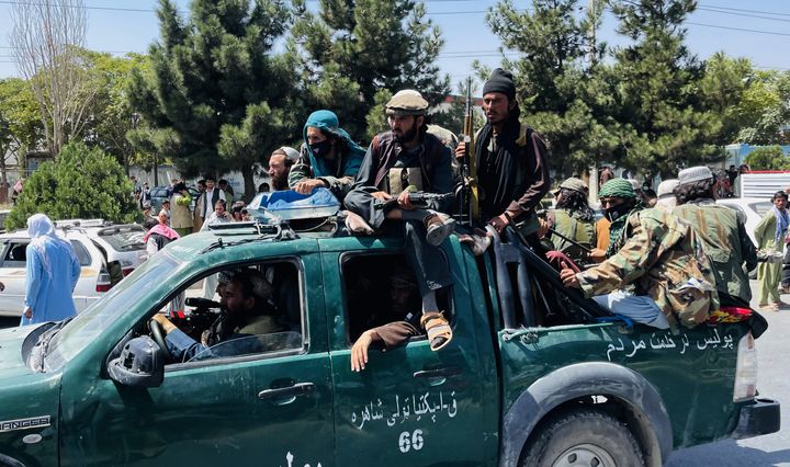  Taliban members are seen near Hamid Karzai International Airport as thousands of Afghans rush to flee the Afghan capital of Kabul