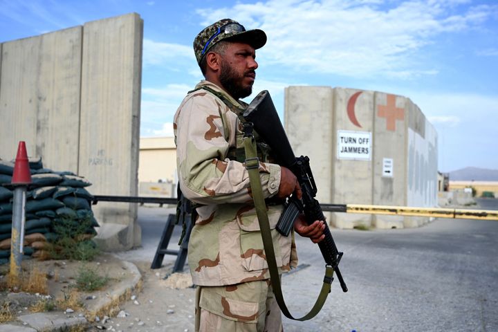 An Afghan National Army (ANA) soldier stands guard at a gate of a hospital inside the Bagram US air base after all US and NATO troops left