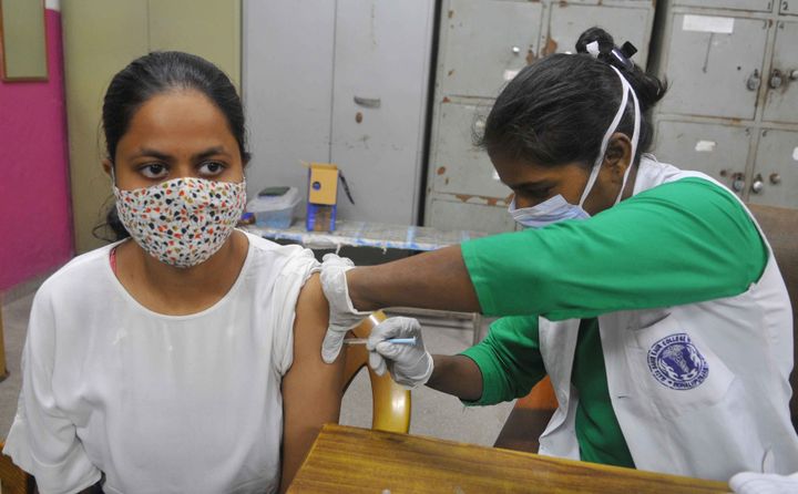 A health worker administers a dose of Covid 19 vaccine to a beneficiary, on August 16, 2021 in Chandigarh, India