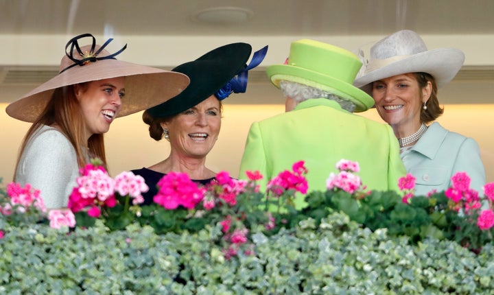 Princess Beatrice, the Duchess of York and Lady Carolyn Warren, right, speak with Queen Elizabeth II in the Royal Box before watching the Queen's horse Elector run on Day 4 of the Royal Ascot on June 22, 2018.