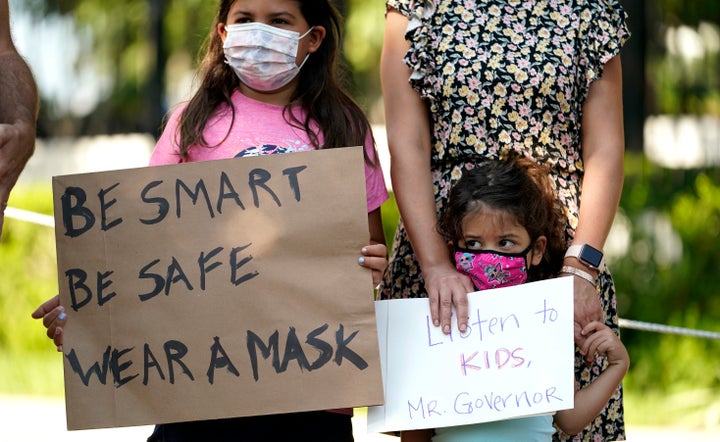 Roxana Weeks, 8, and her sister Farah, 4, protest with other children and parents outside the Texas governor's mansion to urge Gov. Greg Abbott (R) to drop his opposition to public school mask mandates on Monday.